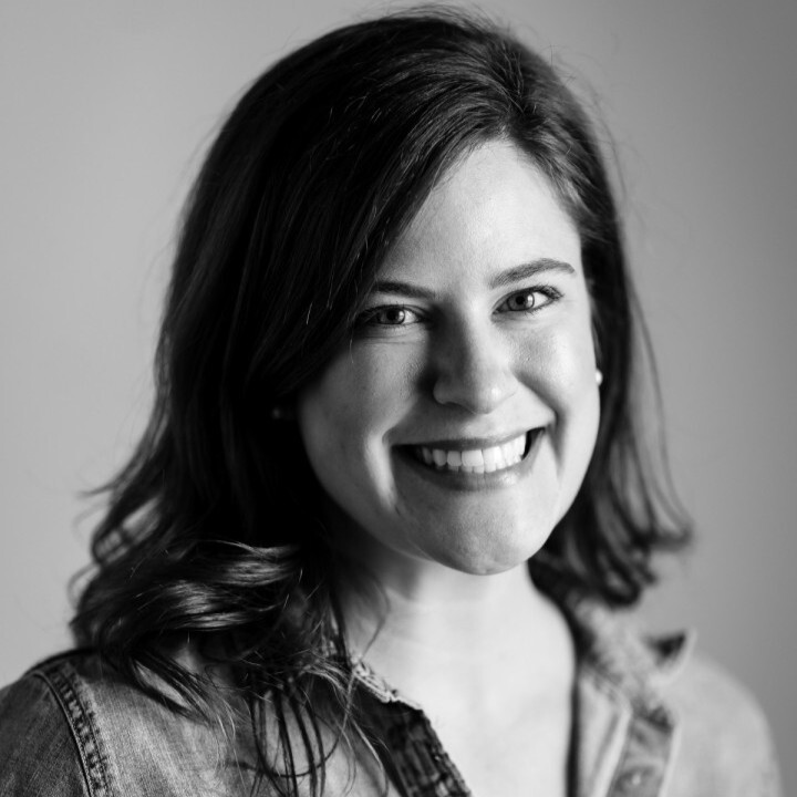 Greyscale photo of Alex Witt smiling.