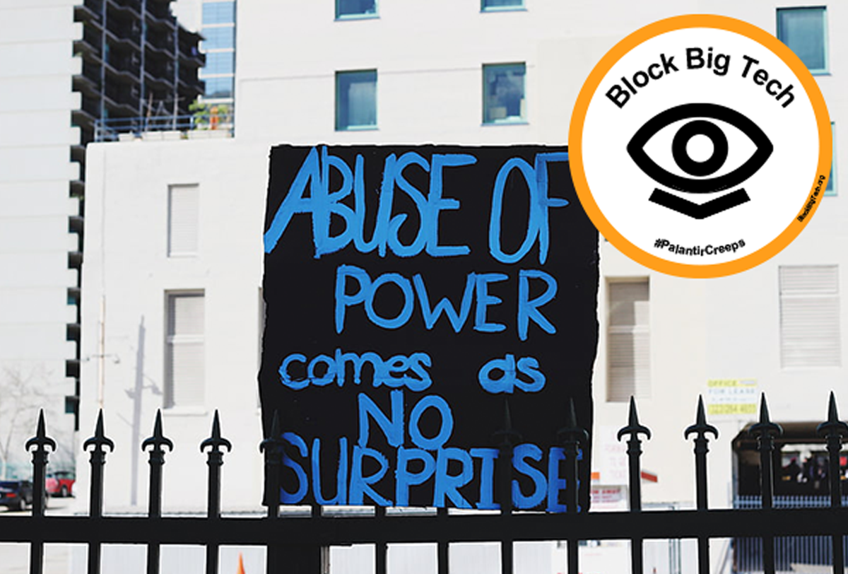 A sign reading 'Abuse of power comes as no surprise' and a sticker reading 'block Big Tech'.