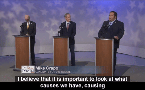 An animated gif of a video clip from a debate held between Idaho Senate candidates, in which David Roth confronts incumbent Senator Mike Crapo for his support of the Trump tax cuts and the negative impact they had on the economy and inflation today.