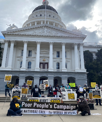 PPC people with signs and a banner in front of the Sacramento Capitol building