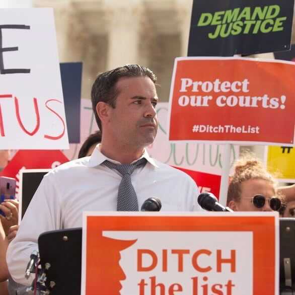 photo of brian fallon at a podium during a protest