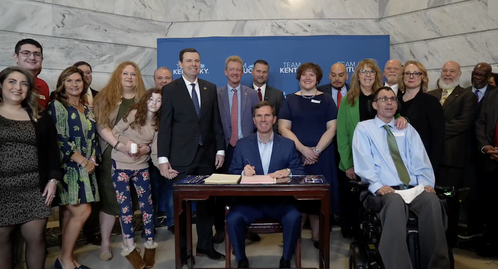 Kentucky NORML’s Lauren Bratcher (left) attends Gov. Andy Beshear’s signing ceremony for SB 47