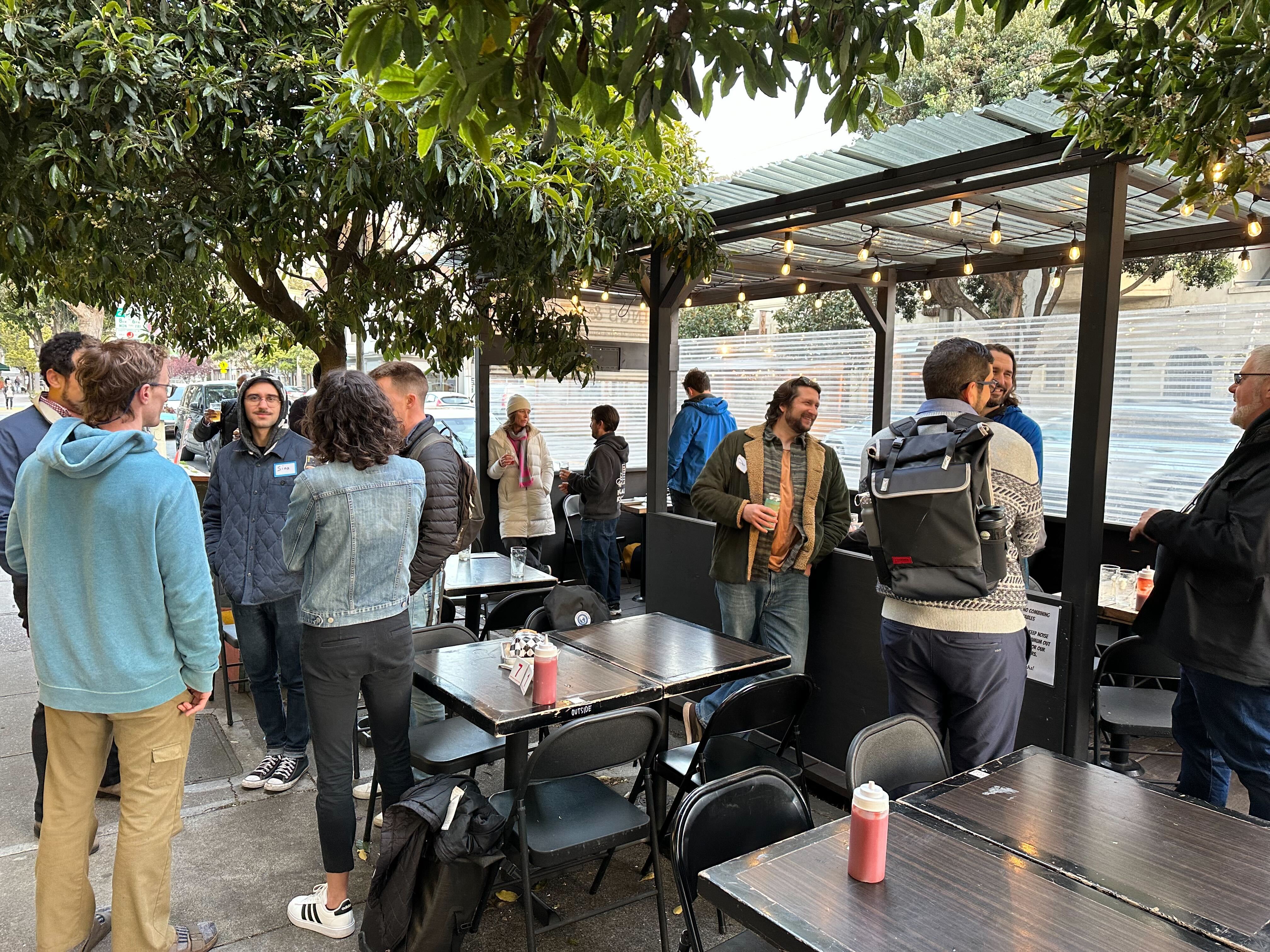 YIMBY members talking to each other at a Februrary happy hour social in February