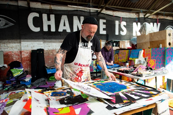 Photo of a man creating posters