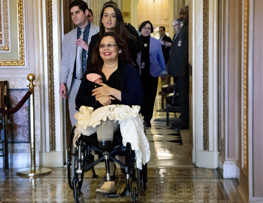 Tammy Duckworth enters the Senate floor with her baby.