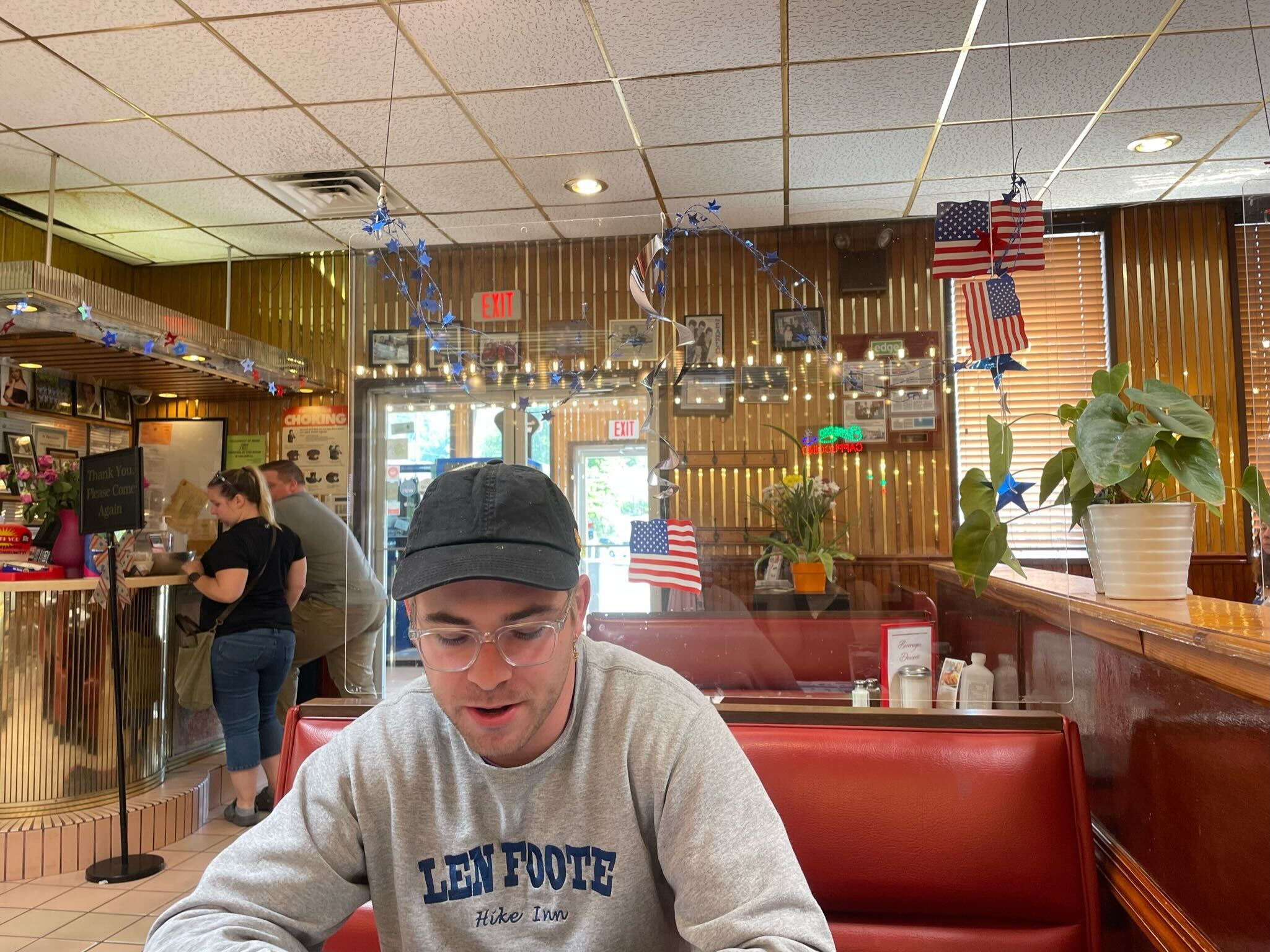 Michael at a diner in a grey sweatshirt