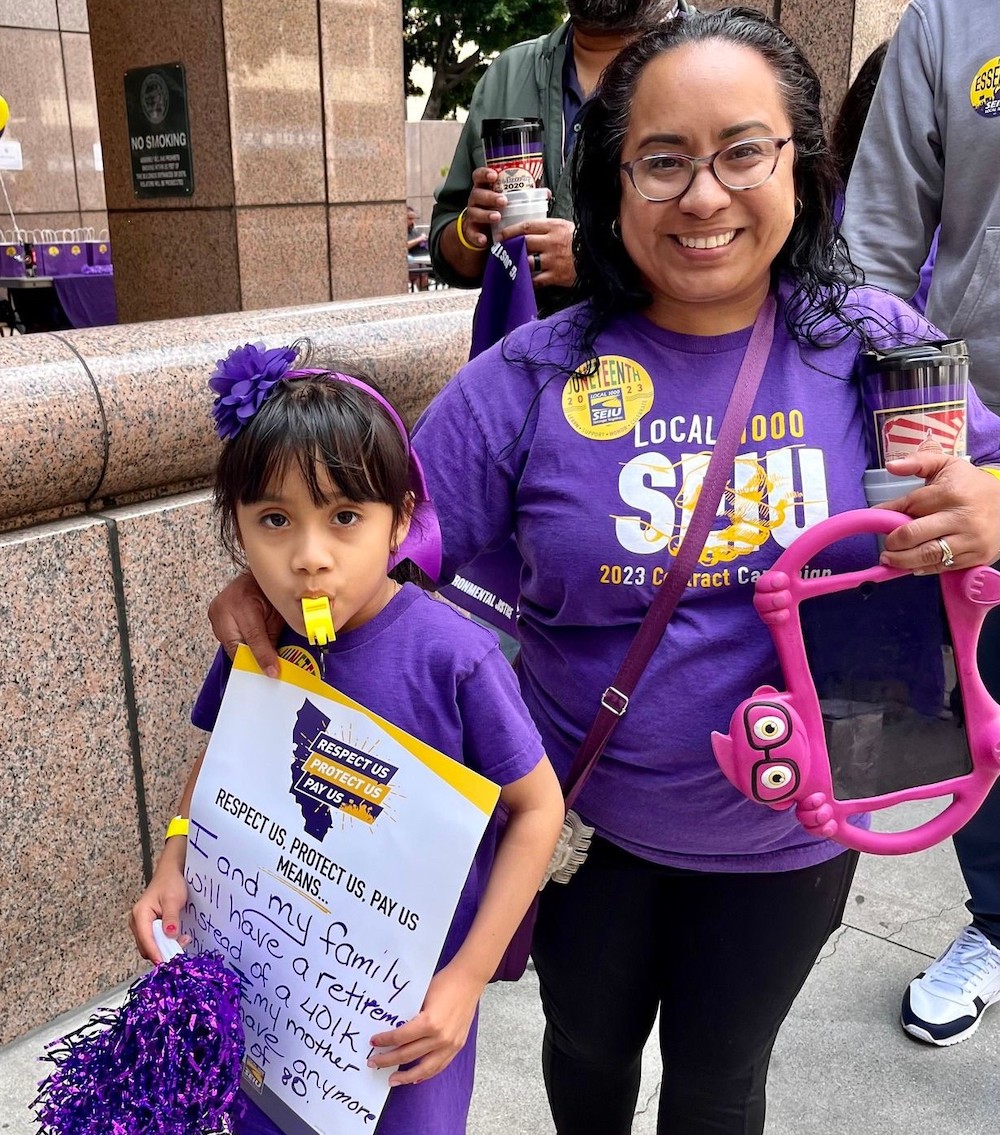 Photo of Rose Gudiel Escobar and daughter at SEIU 1000 action in downtown Los Angeles