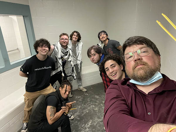  A selfie taken by Jason Call in the holding cell at St. Louis County Jail along with 7 students just before his phone was confiscated.