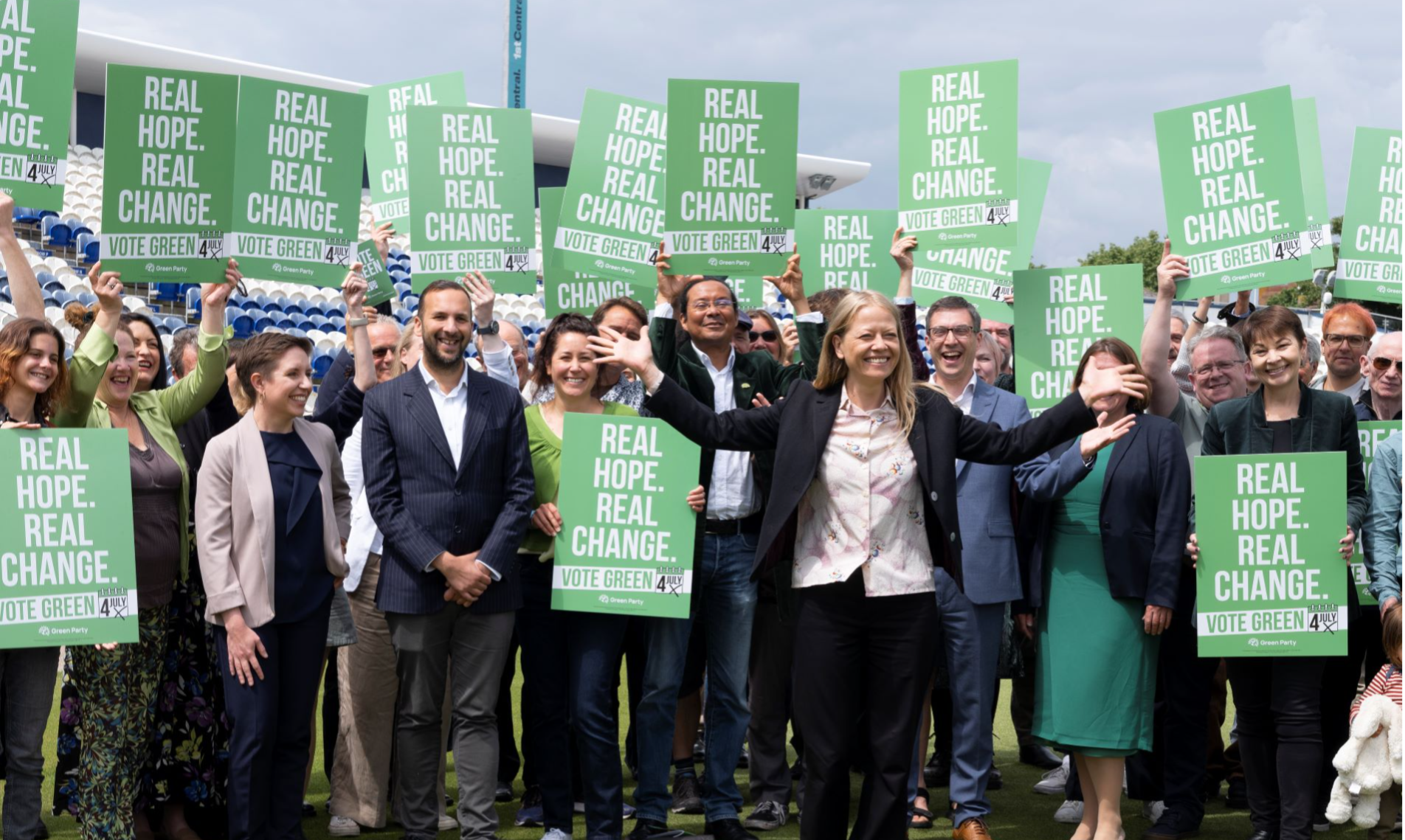 Crowd of Green Party campaigners and Carla, Zack, Sian, Adrian, Ellie and Caroline at Green Party manifesto launch.