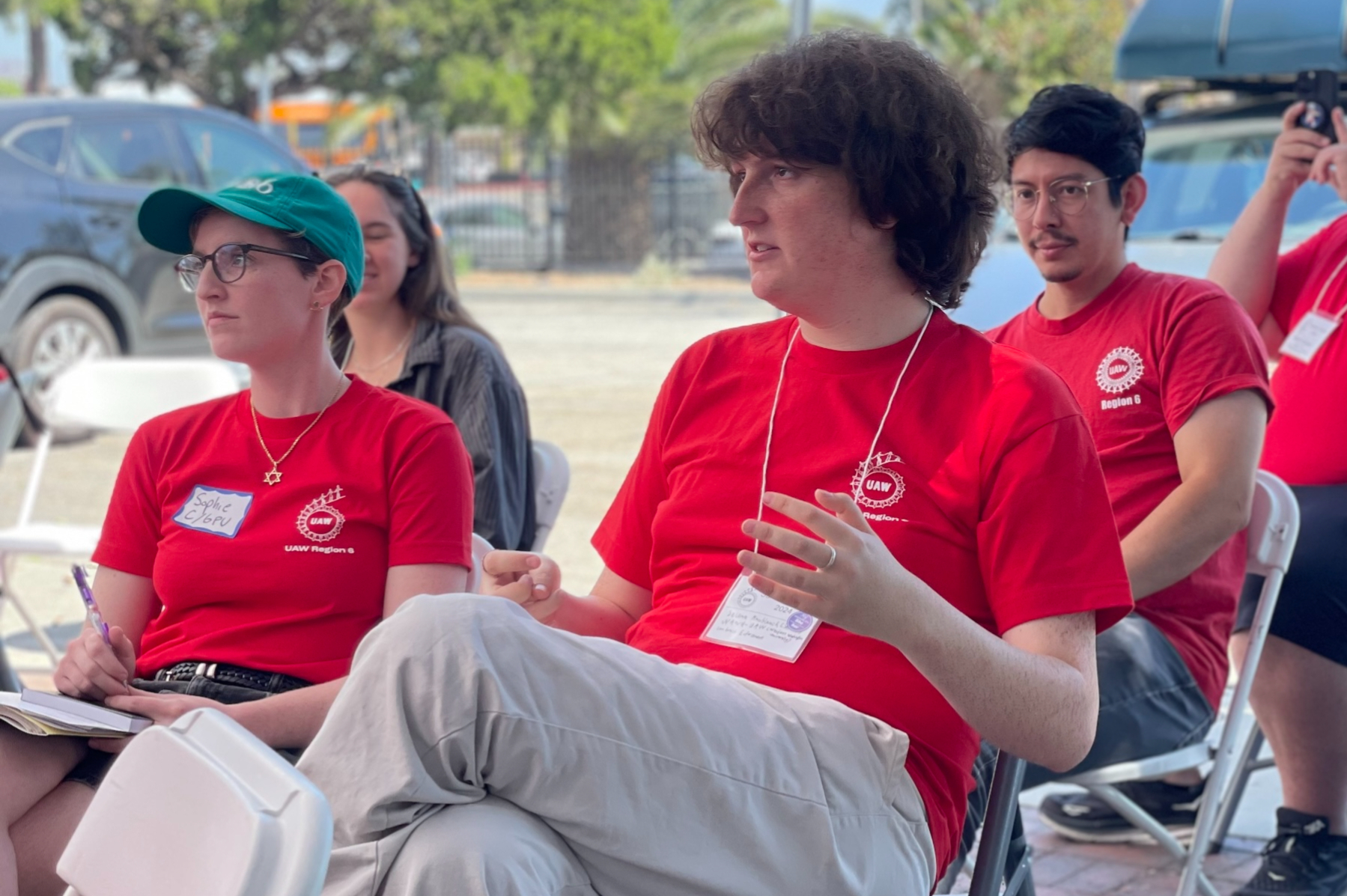 Four people sitting outside talking during a workshop