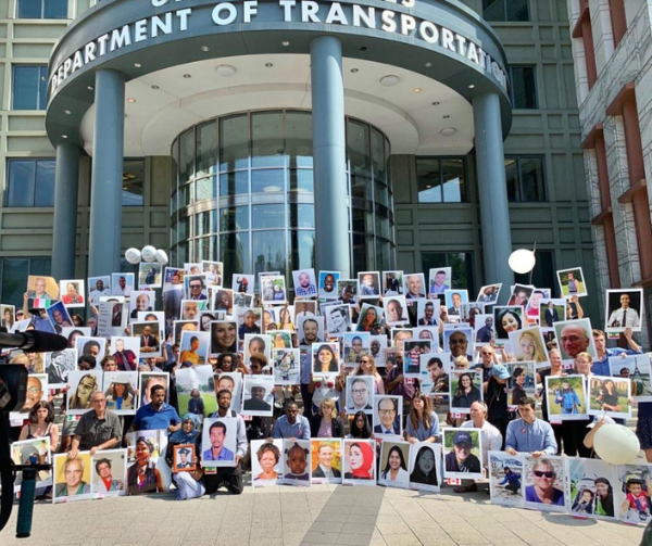 A photo of the families of the Ethiopian Airlines flight 302 crash taken in front of the Department of Transportation in Washington. The crowd holds up photos of their loved ones who died in the crash.