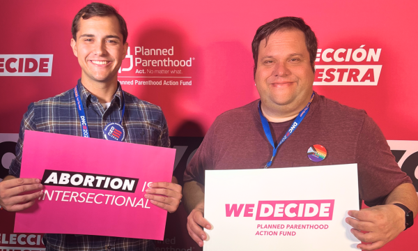 A photo of David and another DNC attendee today posing with pro-abortion signs to support Planned Parenthood.