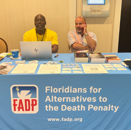 Herman Lindsey and Seth Penalver sitting at FADP's table during the Life Over Death Conference.