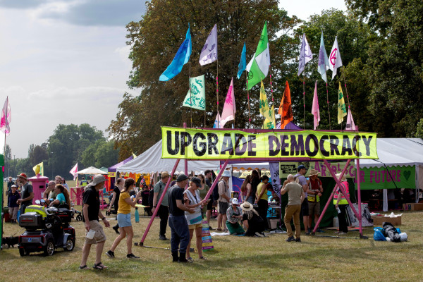 Upgrade Democracy large banner at entrance to campsite