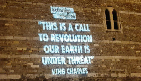 Projection of quote by King Charles on the side of Windsor Castle