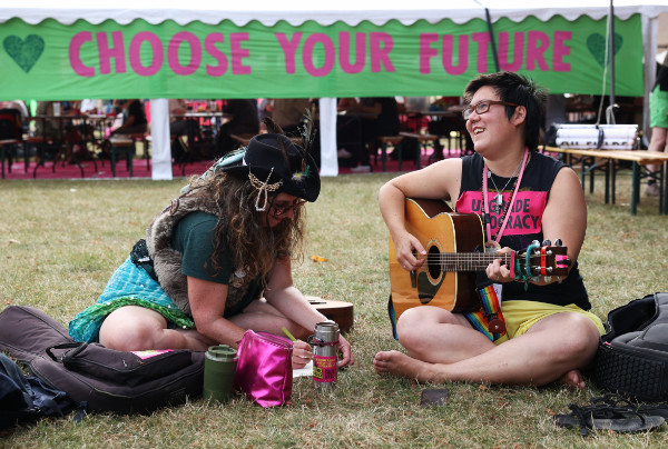 Choose your Future banner back at camp with singer and guitar