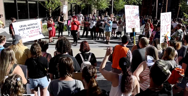 A screenshot of a video from the Idaho Statesman where people in Idaho are rallying for reproductive rights.