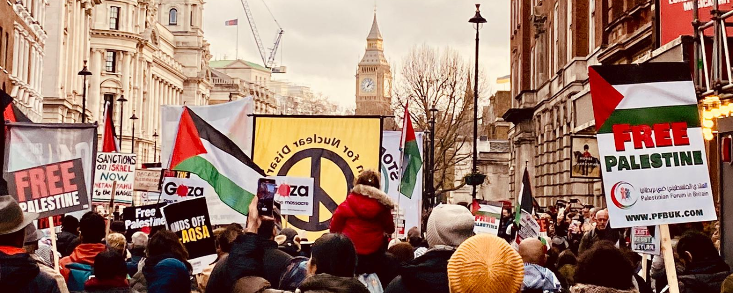 CND banner and Palestine placards on demo with Big Ben visible in background