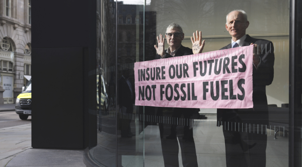 Two men in window while occupying an insurance company lobby