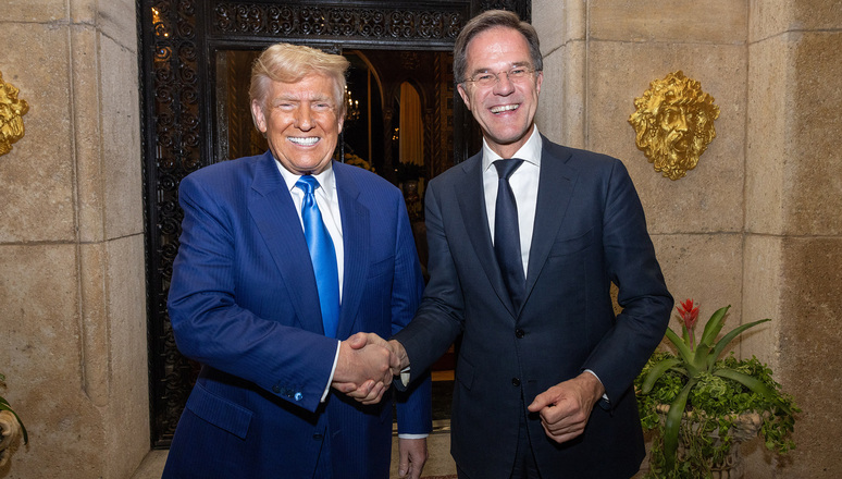 Donald Trump and Mark Rutte shake hands and smile