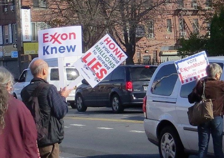 350Brooklyn activists take to the streets with protest signs at an Exxon station in Borough Park, Brooklyn, November 27, 2015