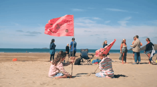 Images of sand art on a beach in St Davids