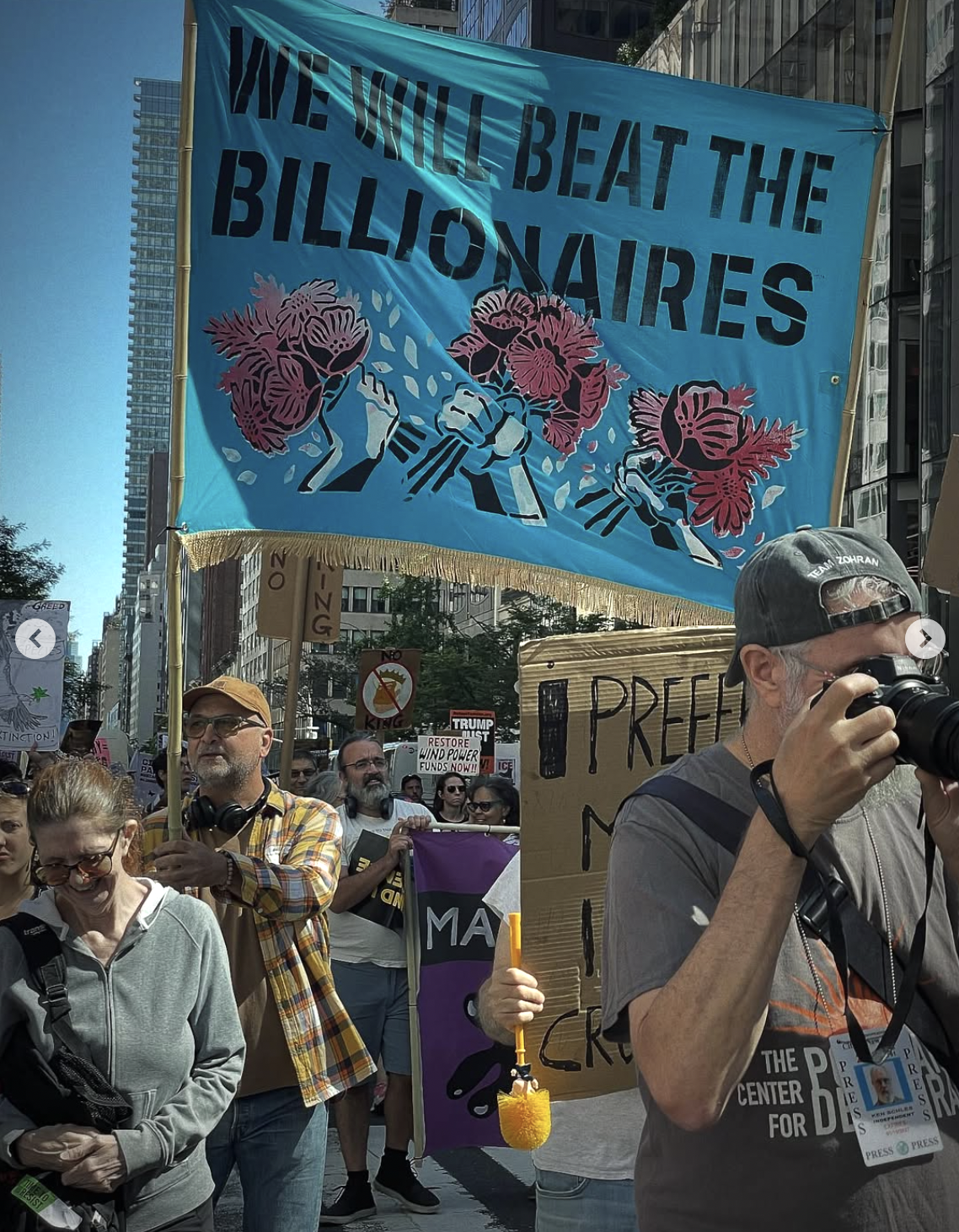 another picture from the march shows people carrying a tall banner that says 