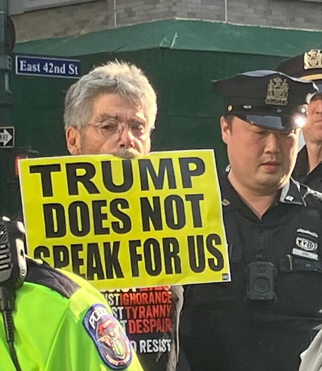 A photo from our protest on Tuesday shows a person holding a sign in their mouth that says 