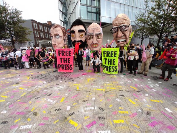 Four giant puppet heads of oligarch press owners