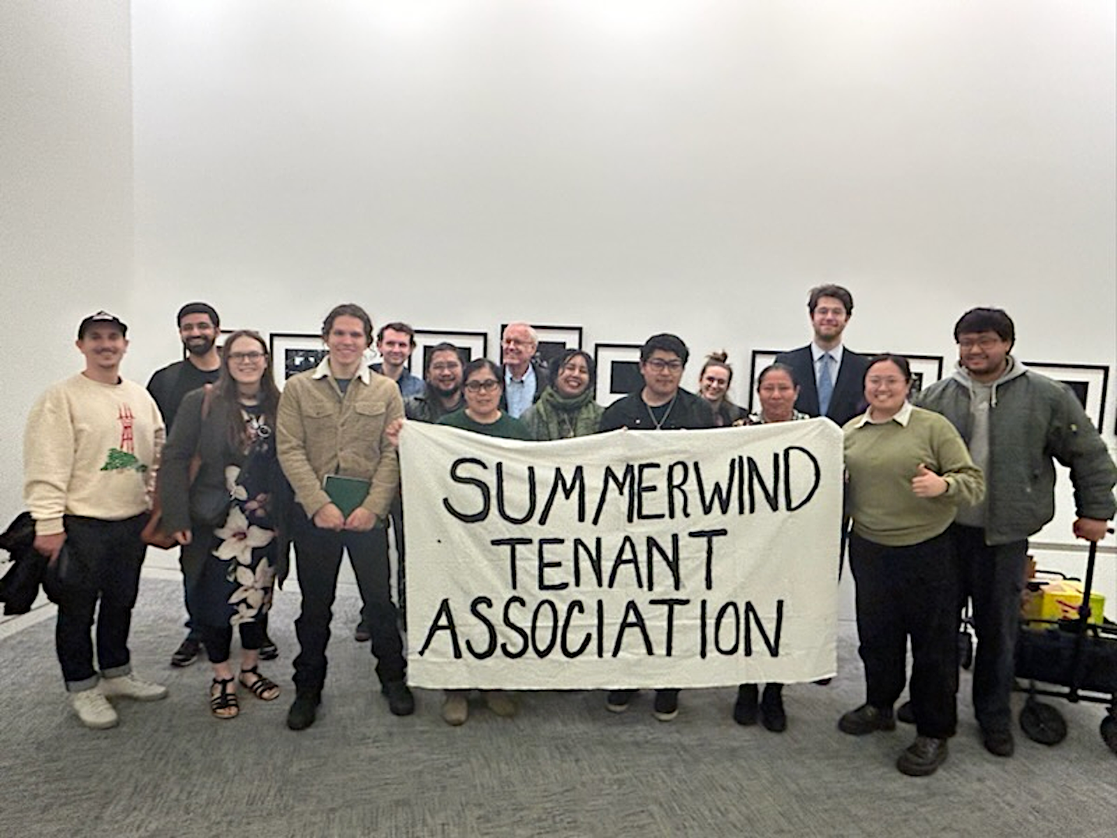People holding up a banner for a tenant association