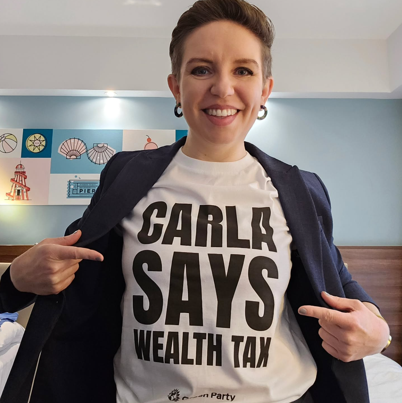Carla Denyer MP pictured in 'Carla Says Wealth Tax' t-shirt