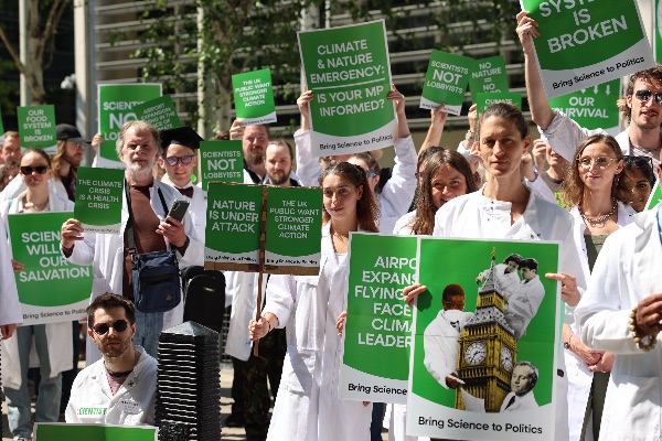 Scientists for XR hold truth telling placards in Westminster