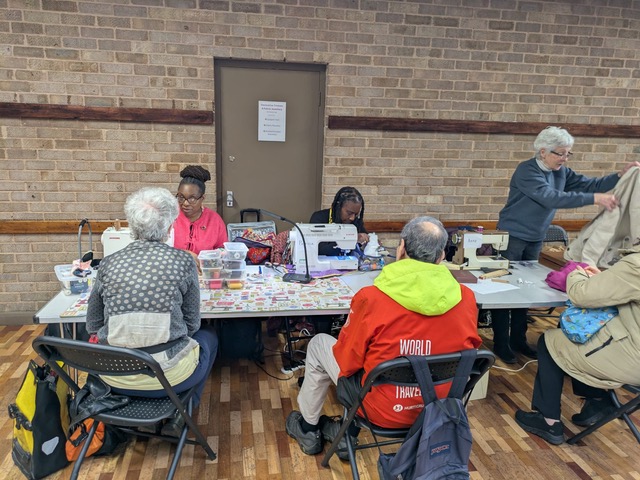 [Three busy at sewing machines for Wanstead residents.]