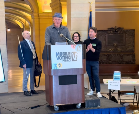 An image of Doug Pagitt speaking in front of the Minnesota State Capitol to expand the “We” through Mobile Voting in Minnesota.