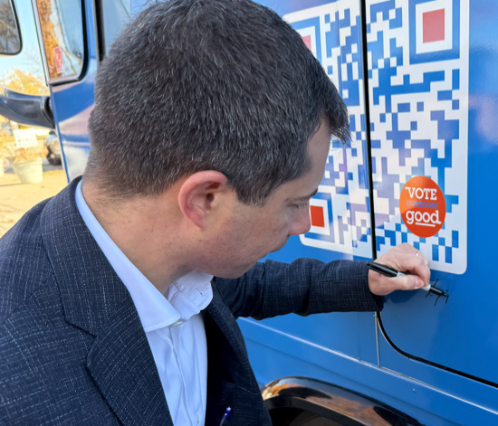 A photo of Pete Buttigieg signing the Vote Common Good bus two years ago.