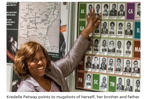 A photo of Kredelle Petway pointing to a mugshot of herself, her brother, and her father.