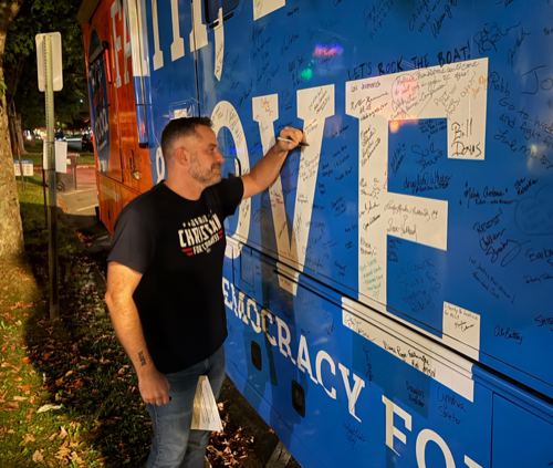 A photo of Ohio candidate Jerrad Christian signing the Faith, Hope, & Love bus.