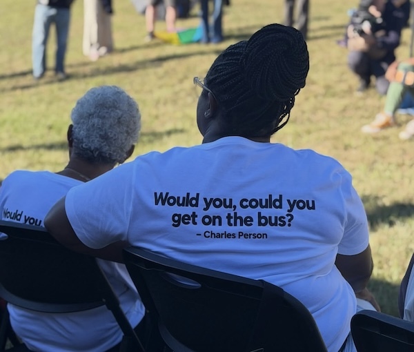 A photo from The Ride of a woman wearing a T-shirt that says, 