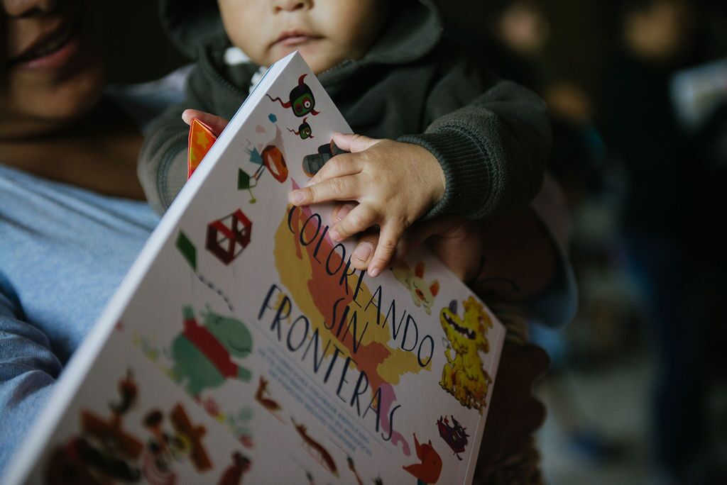 Small child holding Coloring Without Borders