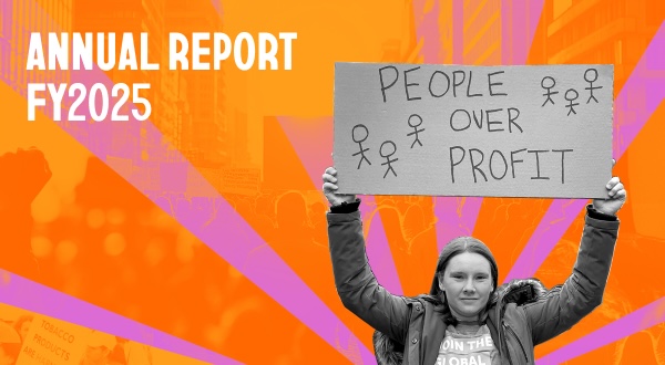 A pink and orange cover of our annual report, featuring an organizing holding up a cardboard sign that says PEOPLE OVER PROFIT.