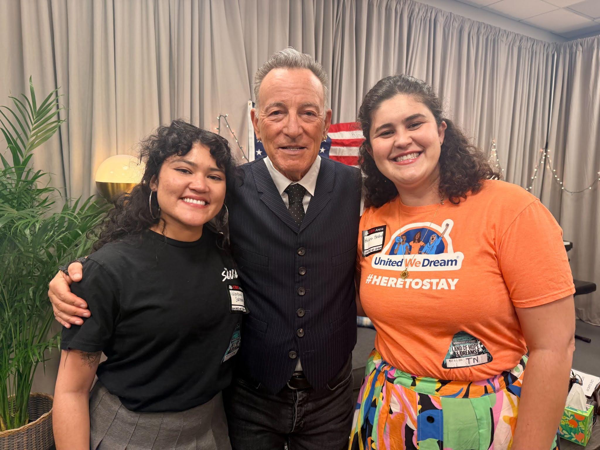 Two United We Dream organizers pose backstage with musician Bruce Springsteen during his 'Land of Hope & Dreams' tour stop in Elmont, NY.